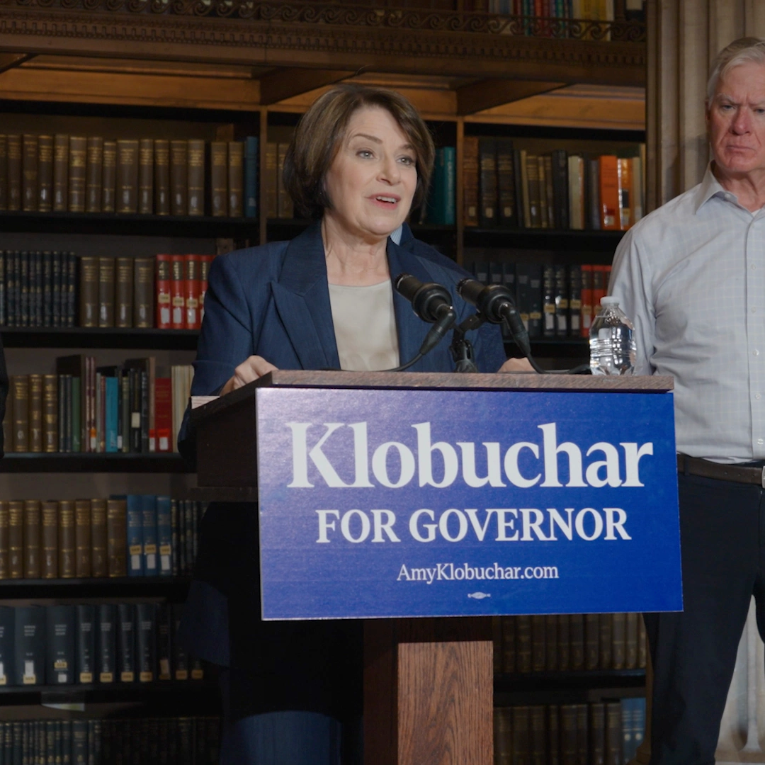 Amy Klobuchar at the podium announcing her plan to root out government fraud