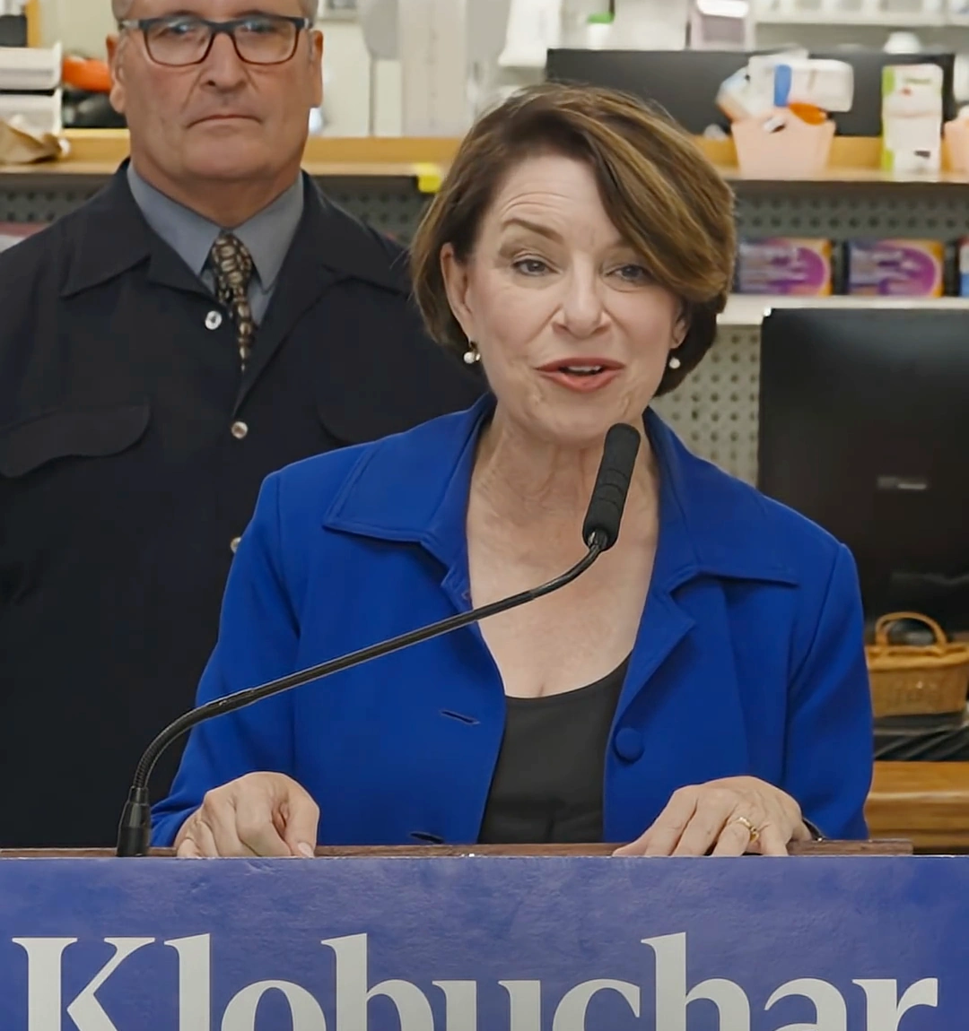 Amy Klobuchar speaking at a pharmacy press conference announcing her health care plan