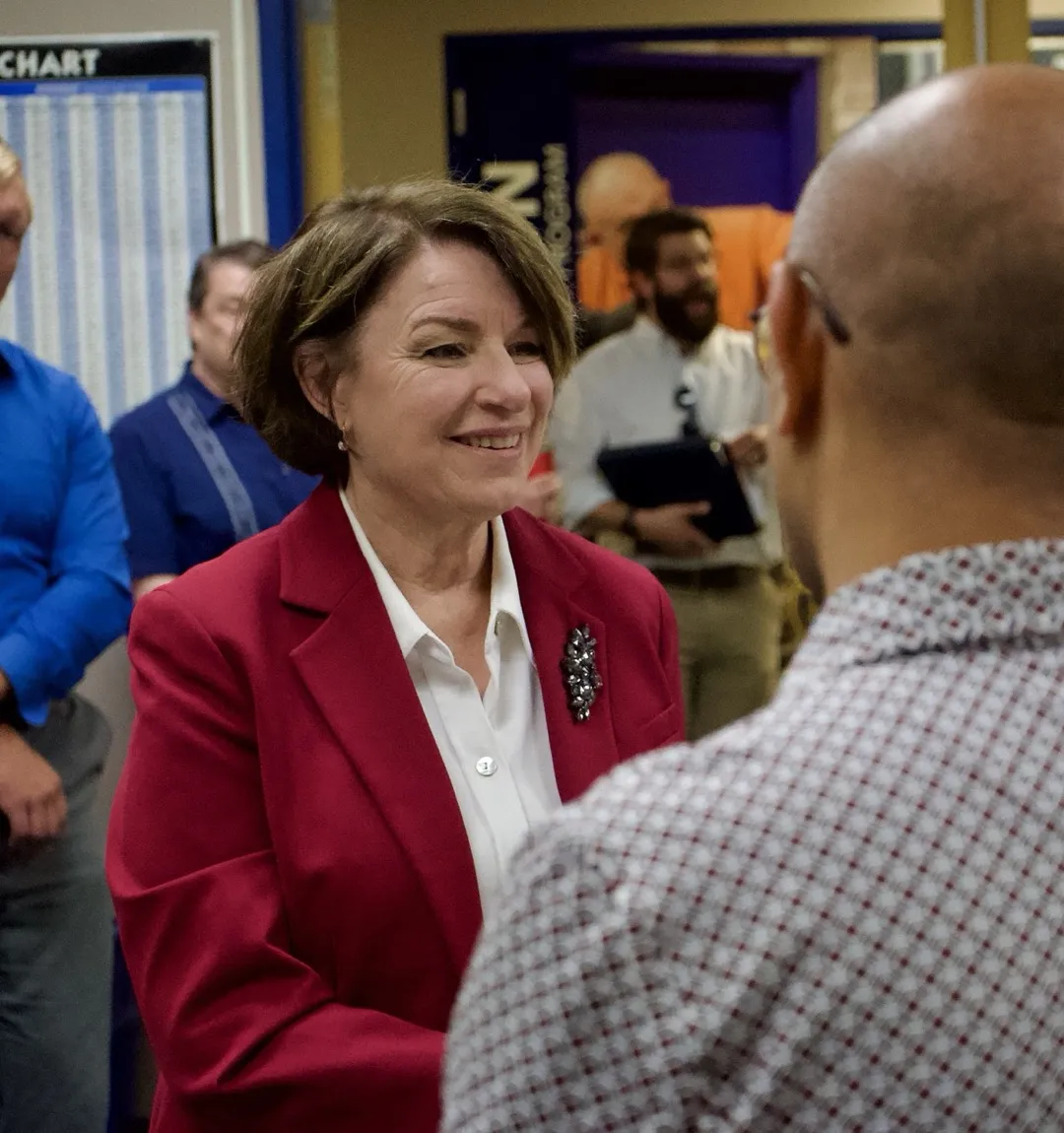 Amy Klobuchar meeting workers during a training center visit